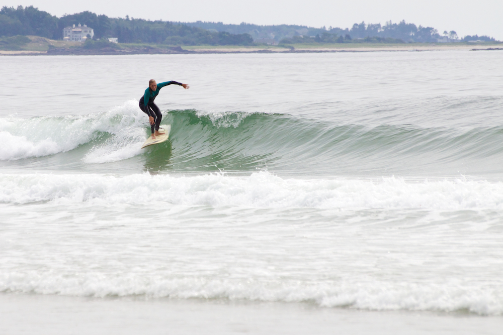 Emily Heath, surf instructor at Surf Camp, charging some fun lines at Scarborough Beach